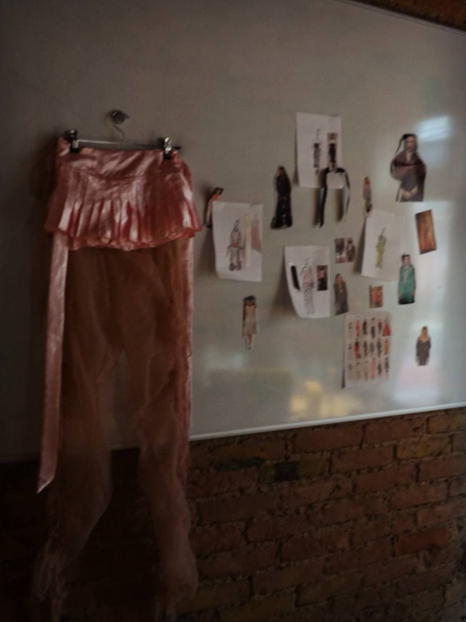 Rose satin skirt against sketch wall