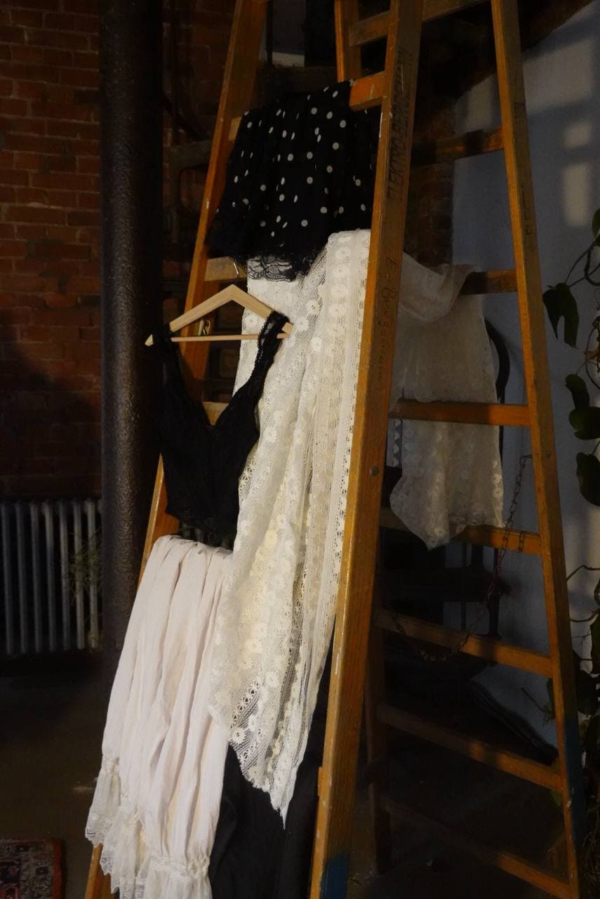 Garments draped on ladder